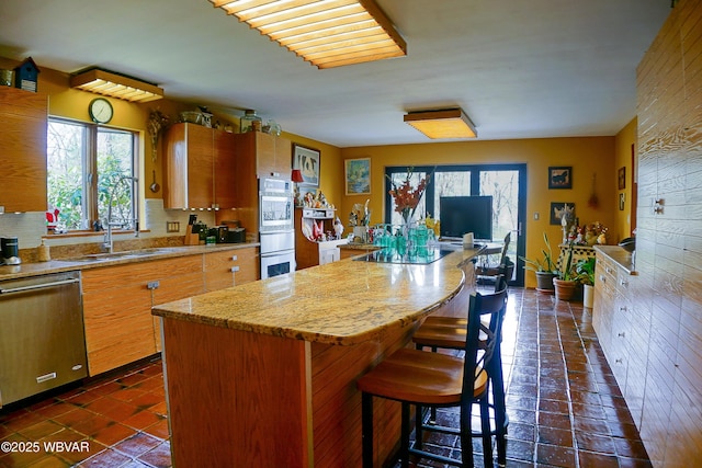 kitchen with a center island, light countertops, a wealth of natural light, and appliances with stainless steel finishes