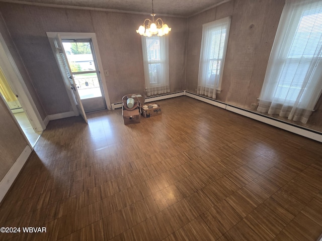 unfurnished dining area featuring a baseboard heating unit and a chandelier