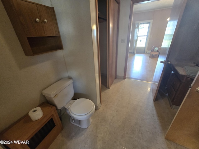 bathroom with toilet and crown molding