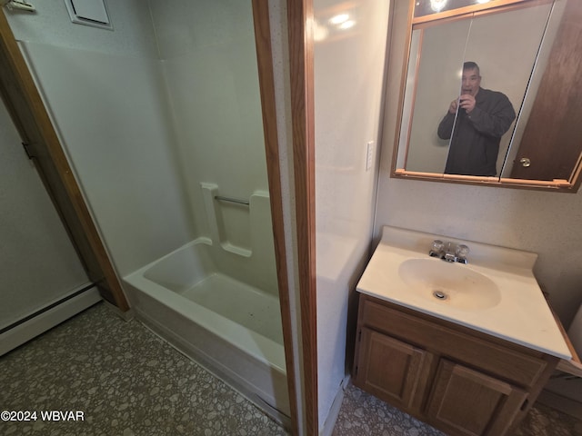 bathroom featuring vanity, walk in shower, and a baseboard heating unit