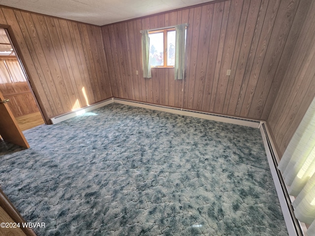 carpeted empty room featuring wood walls