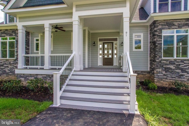 view of exterior entry with a porch and ceiling fan