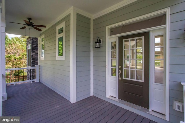 wooden terrace featuring ceiling fan