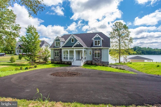 view of front of property with a porch and a front yard