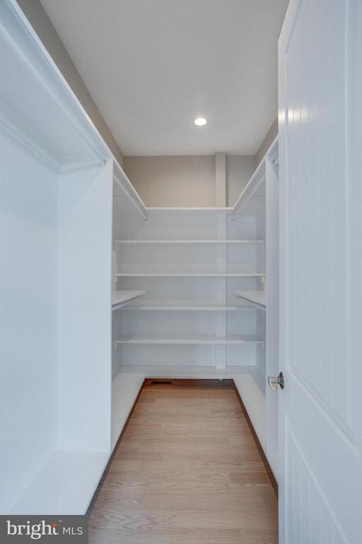 walk in closet featuring light hardwood / wood-style flooring