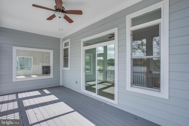 wooden deck featuring ceiling fan