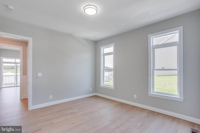 spare room with light hardwood / wood-style floors