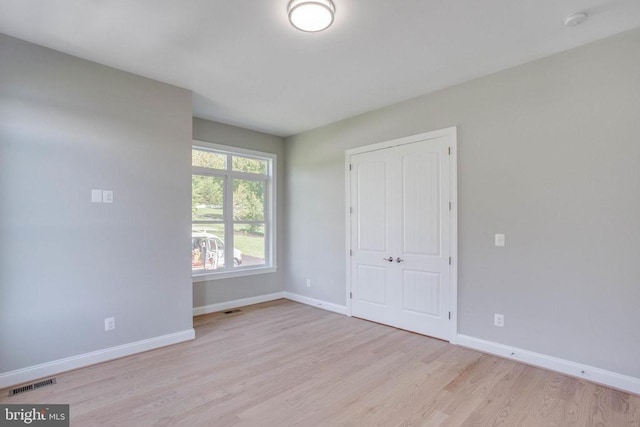 empty room with light hardwood / wood-style floors