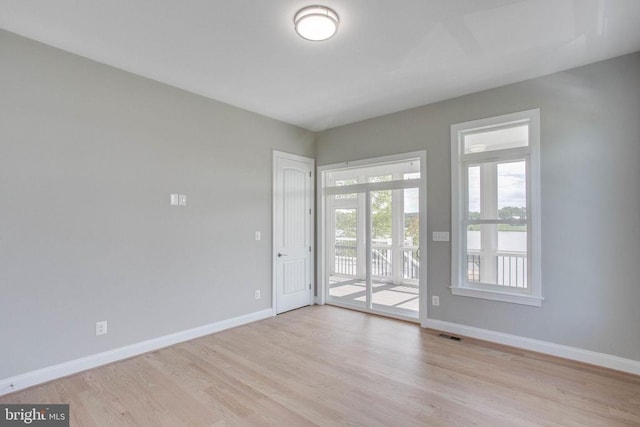 unfurnished room with light hardwood / wood-style floors