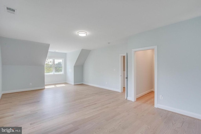 bonus room with light hardwood / wood-style flooring and vaulted ceiling