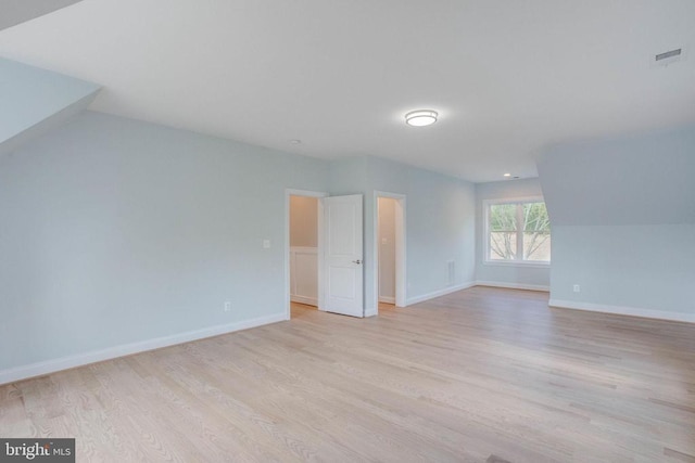 bonus room featuring vaulted ceiling and light wood-type flooring