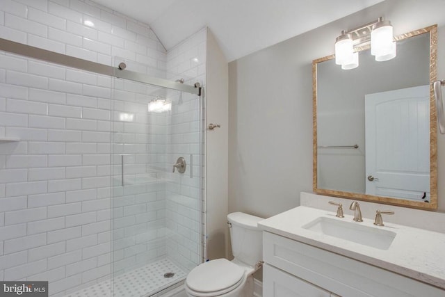 bathroom with a shower with door, toilet, and vanity