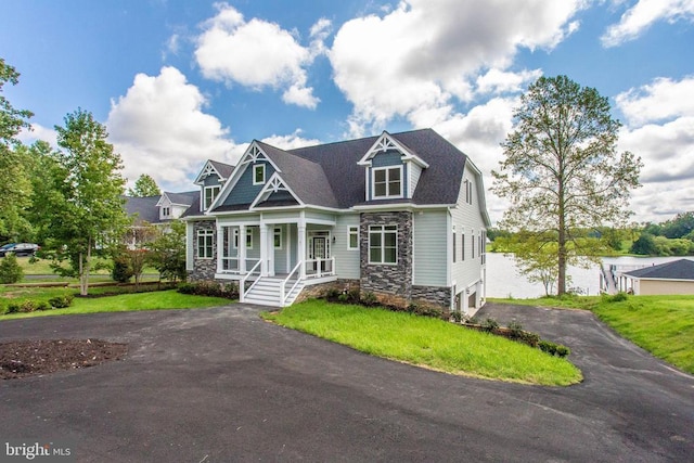 view of front of house with a porch and a front yard