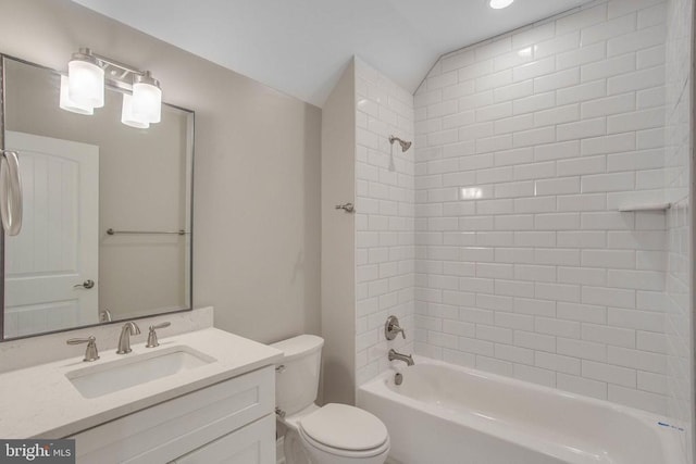 full bathroom featuring toilet, large vanity, and tiled shower / bath