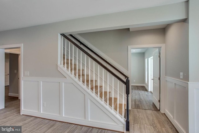 stairs featuring light wood-type flooring