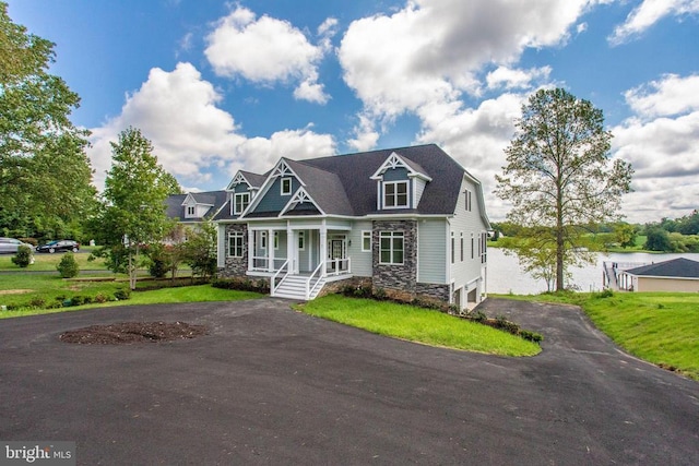 view of front of home featuring covered porch and a front lawn