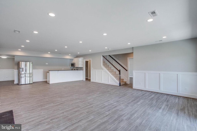 unfurnished living room featuring light wood-type flooring