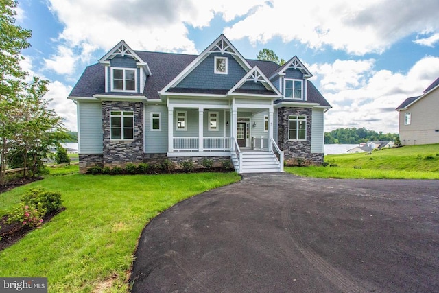 craftsman-style home with covered porch and a front lawn