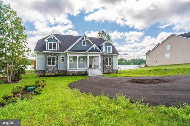 craftsman-style house with covered porch and a front yard