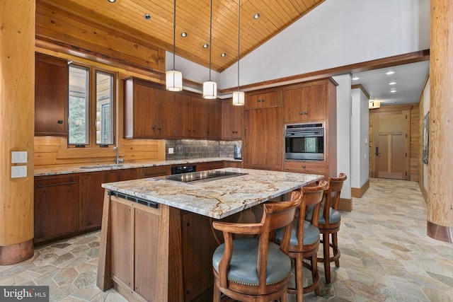 kitchen with light tile flooring, pendant lighting, a center island, a breakfast bar, and stainless steel oven