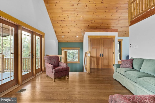 living room with high vaulted ceiling, light hardwood / wood-style floors, and wooden ceiling