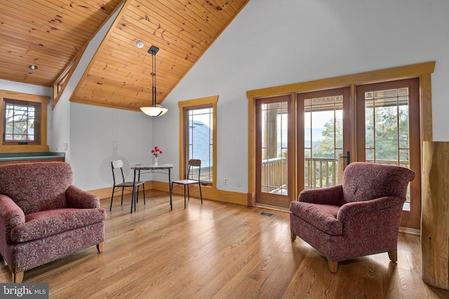 sitting room with wooden ceiling, high vaulted ceiling, light hardwood / wood-style flooring, and a healthy amount of sunlight