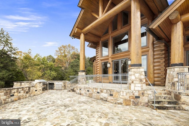 view of terrace featuring french doors and exterior kitchen