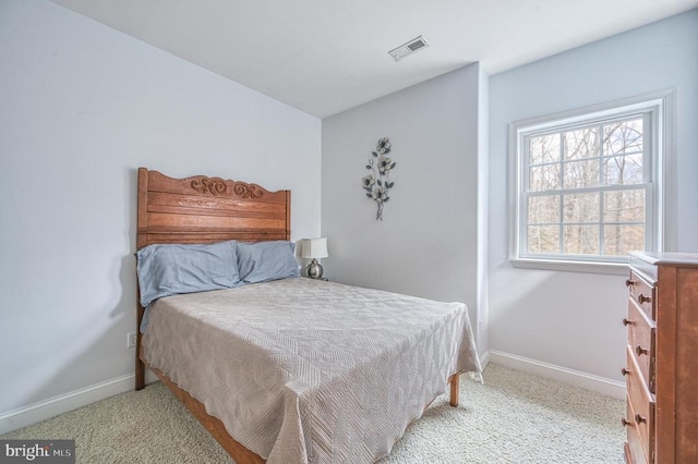 bedroom featuring light colored carpet