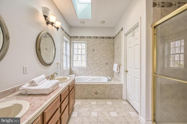 bathroom with dual bowl vanity, tile flooring, plus walk in shower, and a skylight