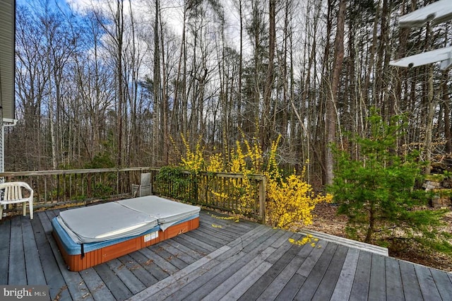 deck with a covered hot tub