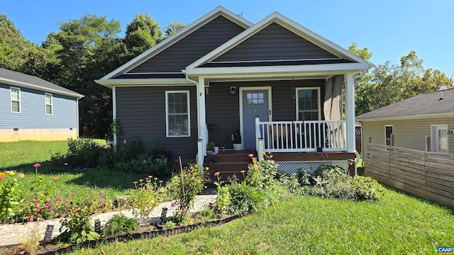 bungalow featuring a porch and a front lawn