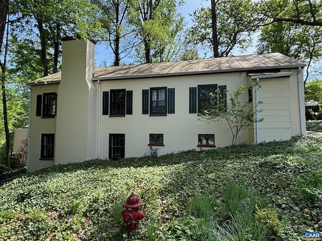 view of side of property featuring a chimney