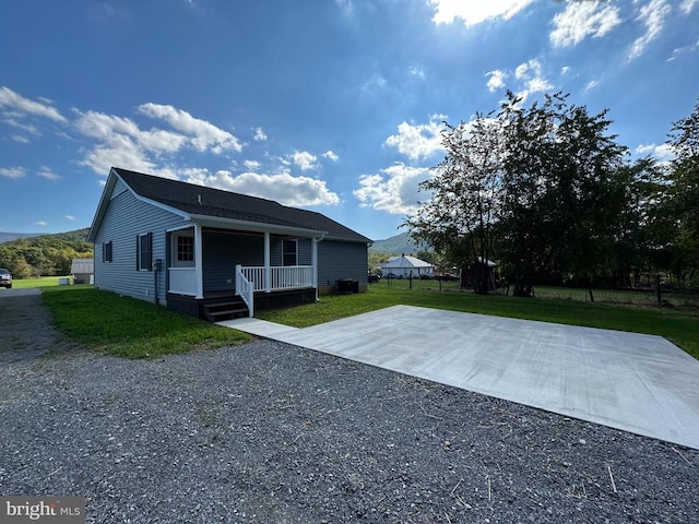 view of front of property with a porch and a front lawn