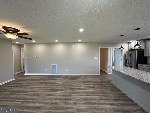 interior space with dark hardwood / wood-style flooring, a textured ceiling, and ceiling fan