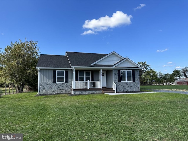 view of front of house with a front yard and covered porch