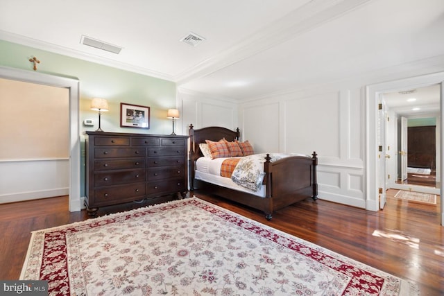 bedroom featuring ornamental molding and dark wood-type flooring