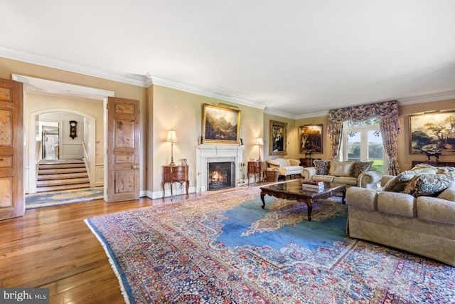 living room featuring hardwood / wood-style flooring and ornamental molding