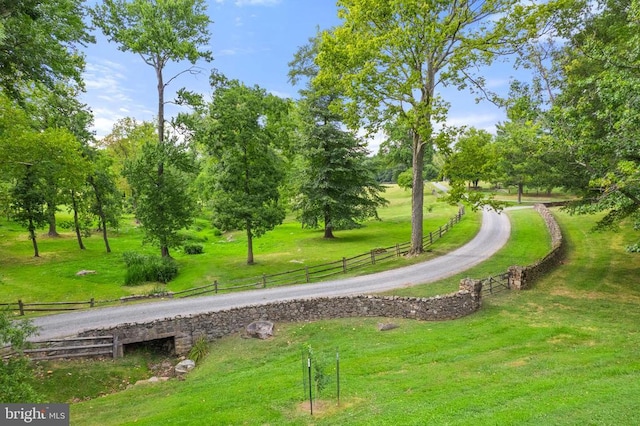 view of home's community with a yard and a rural view