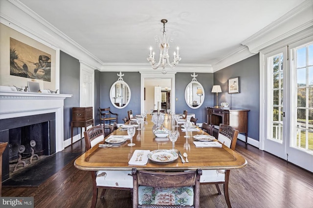 dining room featuring a healthy amount of sunlight, crown molding, dark hardwood / wood-style floors, and an inviting chandelier