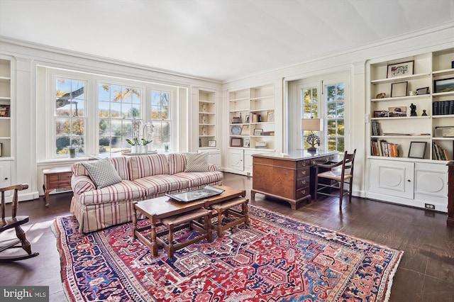 living room featuring crown molding, dark hardwood / wood-style floors, and built in features