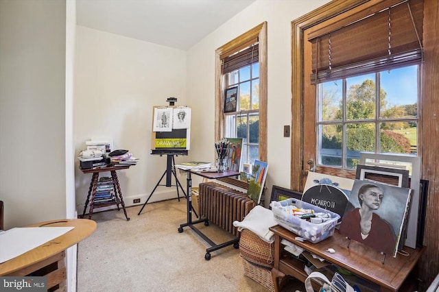 carpeted home office with radiator heating unit