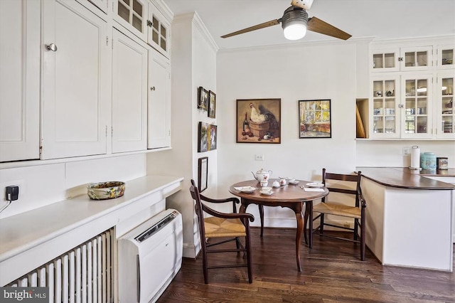 dining area featuring crown molding, dark hardwood / wood-style floors, and ceiling fan