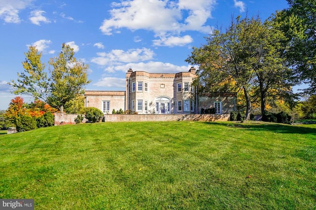 rear view of house with a yard