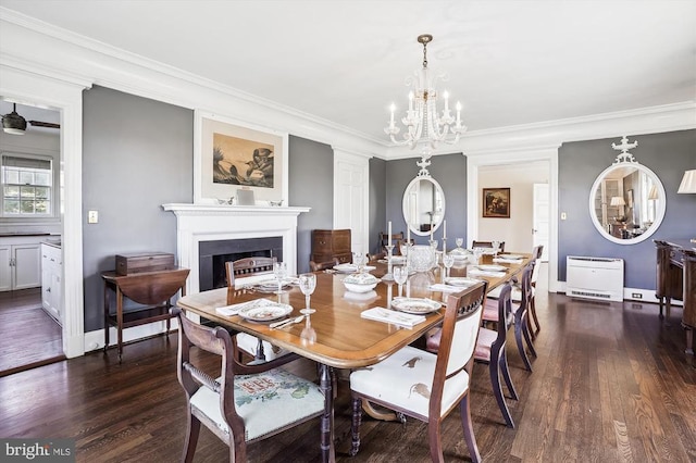 dining room featuring a chandelier, dark hardwood / wood-style floors, and crown molding