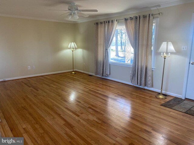 empty room featuring ornamental molding, ceiling fan, and hardwood / wood-style floors