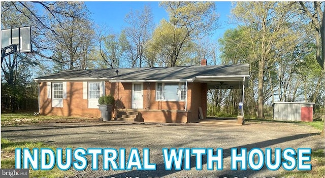 view of front of home with a storage shed and a carport