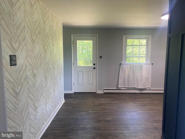 entrance foyer with dark hardwood / wood-style floors, baseboard heating, and plenty of natural light