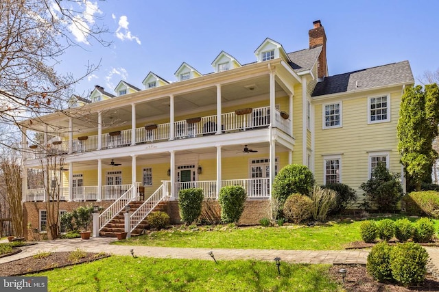 view of front of property with a front lawn, a balcony, covered porch, and ceiling fan