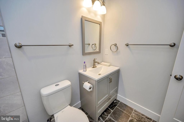 bathroom featuring vanity, toilet, and tile flooring