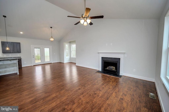 unfurnished living room featuring ceiling fan, high vaulted ceiling, and dark hardwood / wood-style flooring